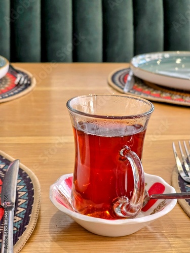 Glass of tea on wooden table in turkish restaurant