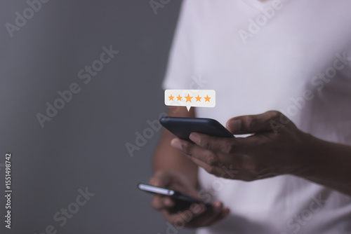 Review Customer, Young Man hand using smartphone mobile with five star to review and give 5 stars with very good results in service, Good review 5 star rating choice feedback