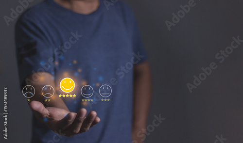 Review Customer, Young Man hand holding emoji five star to review and give 5 stars with very good results in service, Good review 5 star rating choice feedback
