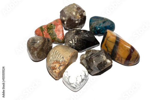 Collection of holistic healing crystal pieces and rocks spiritual on a white background tigers eye and garnet