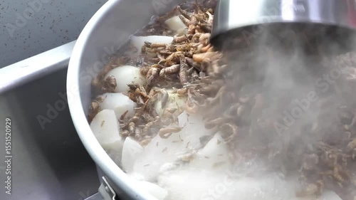 A pot of boiling water steams gently as dried shrimp and root vegetables simmer together to create a savory and flavorful dish.