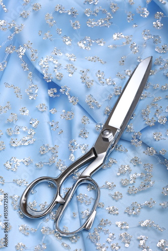 Luxurious blue crystal lace on matching silk satin base and scissors—high-fashion fabric texture perfect for couture, bridalwear, or luxury design projects. Sophisticated, shimmering, and stylish.
