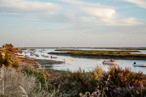 Boats on the water in the beautiful natural park of Ria Formosa Faro, Portugal