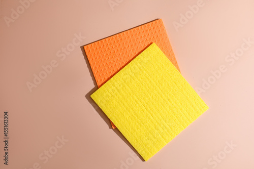 Sunburst and tangerine dishcloths on taupe, a vibrant nod to National Clean Up Day and Global Handwashing Day