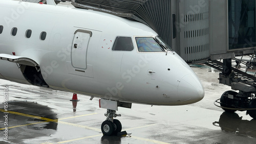 Sleek jet on rain-kissed tarmac, awaiting adventure; perfect for Dia de los Muertos or aviation enthusiasts' dreamscape