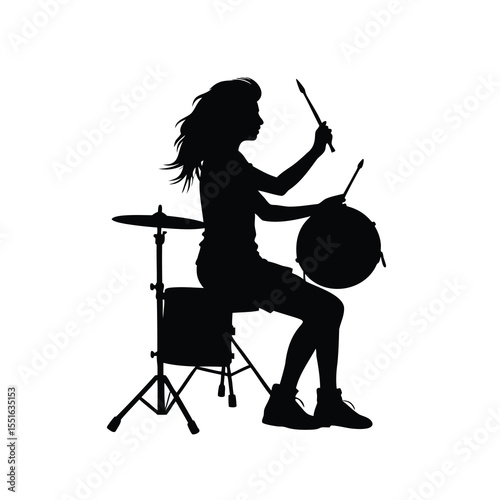 Silhouette of a female drummer playing with passion and intense concentration