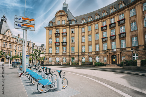 LUXEMBOURG. Row of city bikes for rent on a background of bank building