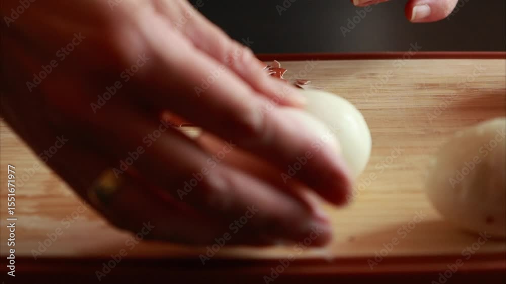 woman hands peeling hard boiled egg close up