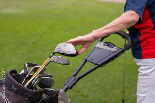 senior woman choosing a golf club