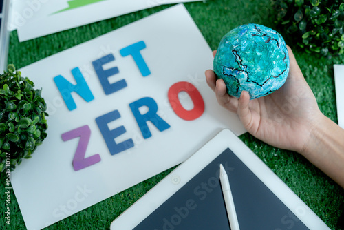 Close-up of businessman's hands gently holding globe, symbolizing eco-conscious business and global care.