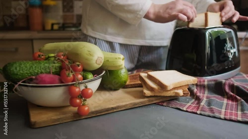 Morning routine woman uses toaster to make crispy toast with vegetables healthy breakfast at home start of the day with fresh meal
