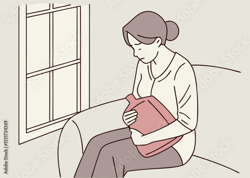 Woman feeling unwell holding a hot water bottle, sitting on a couch near a window, for blogs and websites