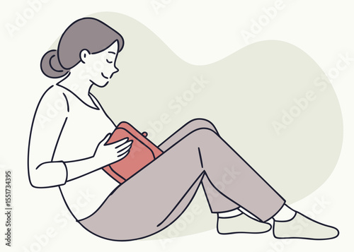 Pregnant woman smiling while holding a book, seated against a light green background, for blog posts