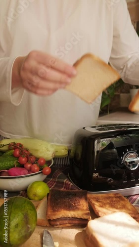 Woman prepares morning avocado toast with vegetables easy and tasty breakfast at home for a healthy start