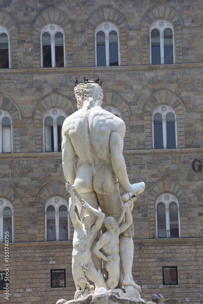 Fototapeta premium rear view of Neptune statue as part of the fountain on Piazza della Signoria in Florence, Italy