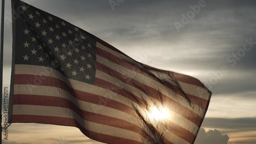 Close up USA American flag waving in the sky against sunset, sunrise outside background. Concept Fourth of July, 4th of July, Independence Day, Veteran Day, Holiday, Celebration. Freedom, Celebration