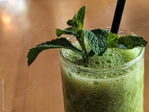 Horizontal image of green smoothie with spinach and mint
