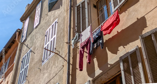 Colorful laundry drying on shutters in Le Panier, Marseille, Marseilles, France. Mediterranean facade detail, summer light, Provence authenticity photo