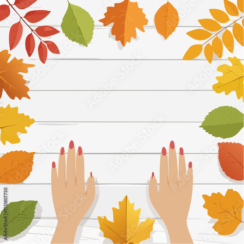 Autumn leaves frame with hands and red manicure on a wooden surface