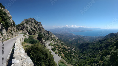 Scenic Winding Mountain Road Overlooking a Coastal Town and the Blue Mediterranean Sea under Clear Sky