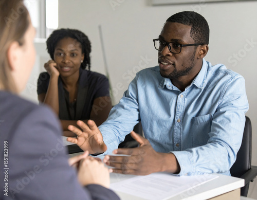 High-quality workplace photography showing supportive conversation about mental health accommodation between manager and employee, soft private office lighting, authentic supportive discussion, confid
