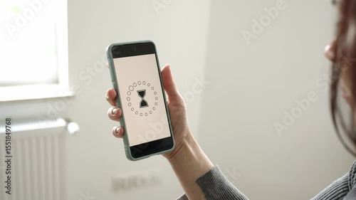 Girl Holding Smartphone, Waiting With Rotating Hourglass Sandglass