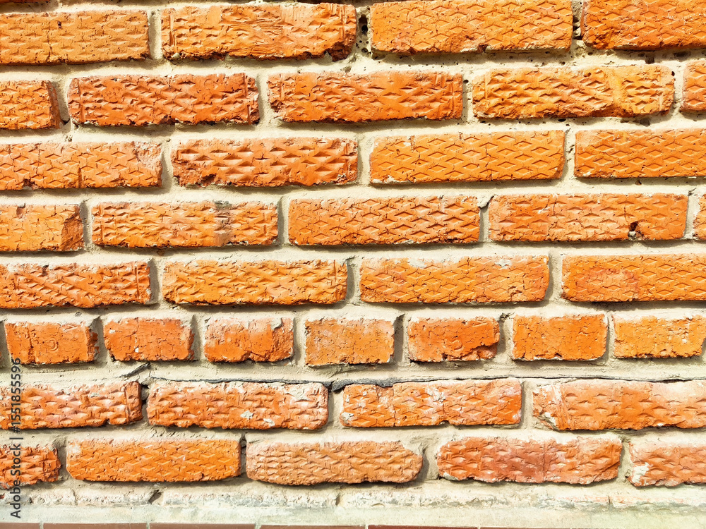 Obraz premium Textured orange brick wall suitable for various design projects