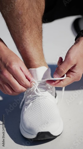 Lacing up vibrant running shoes on a sunny morning in a lively urban environment promoting fitness and determination