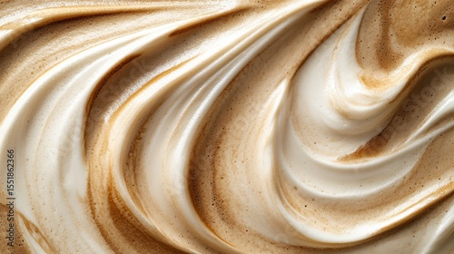 Close-up of swirled creamy texture, light and dark brown tones, abstract food background.