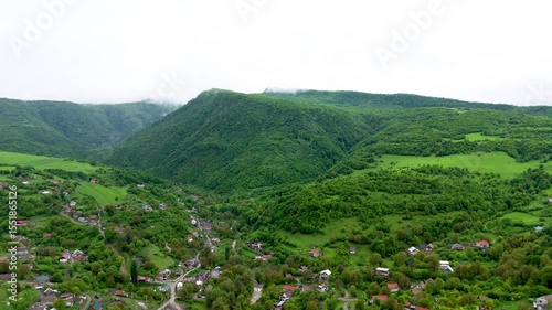 Above view village town in Lori Province,  Armenia, West Asia. Drone footage houses in green landscape. Drone fly over village and green forest.