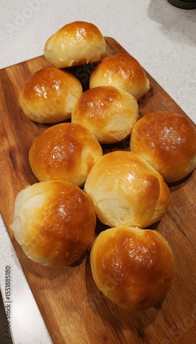 Freshly baked sweet buns with a slightly misshapen appearance and golden crust