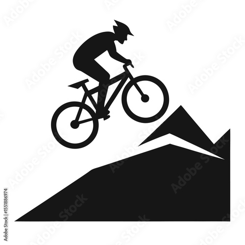 Silhouette of mountain biker performing a jump over an obstacle on a trail