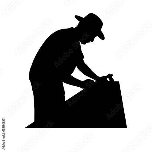 Silhouette of a worker shaping wood with tools in steady stance  