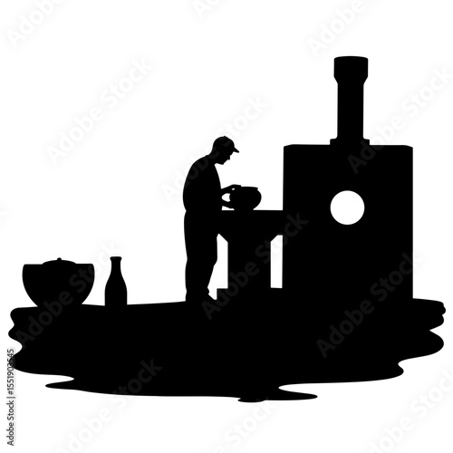 Silhouette of a potter shaping clay on a pottery wheel in studio  