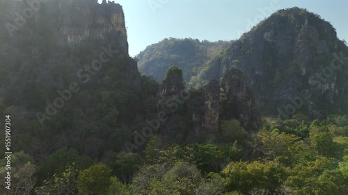 Drone flight through lush forested limestone cliffs