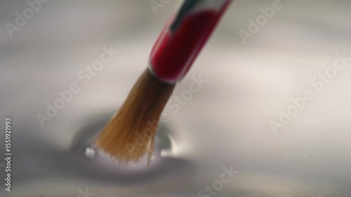 Cleaning water color paint brushes in jar of water