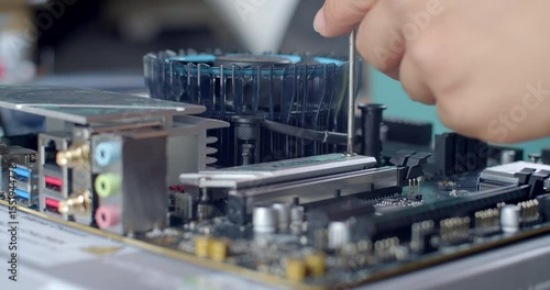 Removing the SSD heatsink by unscrewing it to prepare for SSD installation.
The heatsink is unscrewed and lifted off to allow access to the M.2 slot for installing a new solid-state drive.
