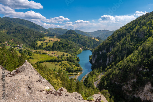 View of the mountain lake and wooded slopes