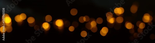 Blurred lights are lit up in the dark and are yellow