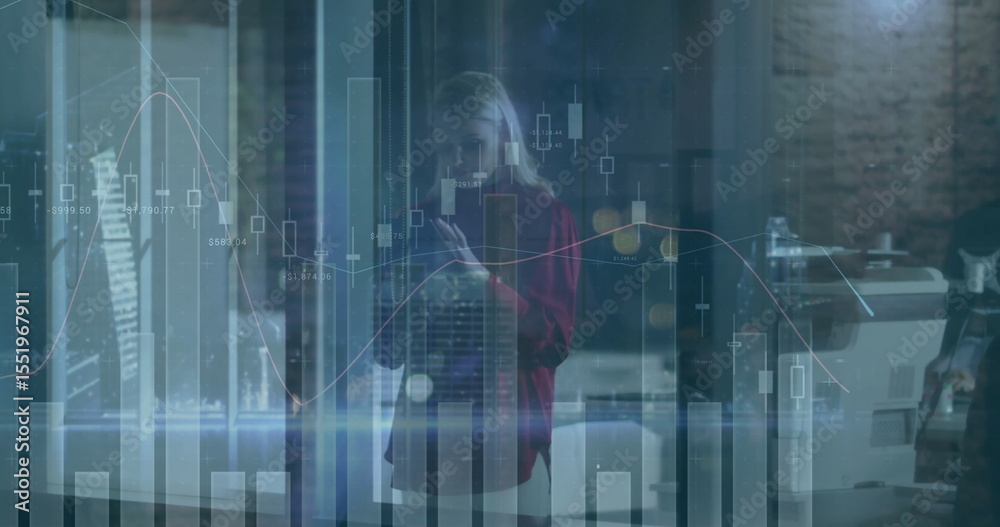 Obraz premium Analyzing financial charts on glass panel in office, wearing red blazer with smartphone near copier