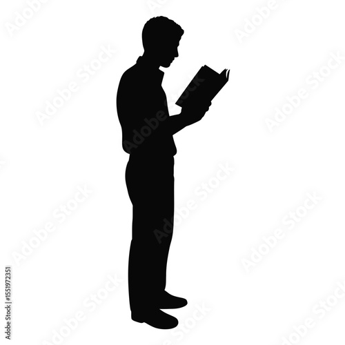 Silhouette of a man standing and reading a book intently
