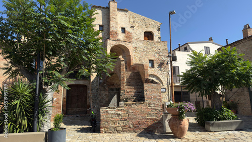 Ancient Stone House with Brick Staircase and Trees in Aliano, Basilicata, Italy