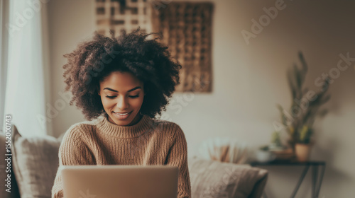 Young woman engages with a laptop while sitting comfortably at home in a cozy and inviting living space