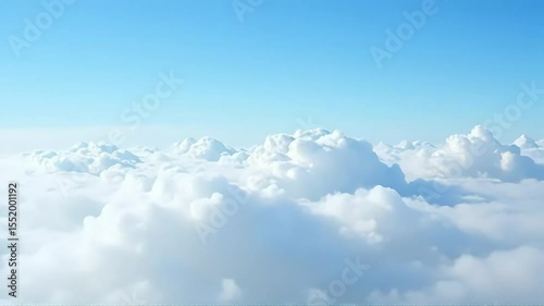 Serene Aerial View of Fluffy White Clouds and a Bright Blue Sky Perfect for Backgrounds and Travel Documentaries
