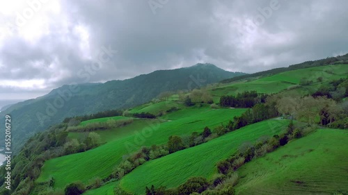 Aerial drone footage of Sao Miguel Island Azores showcasing green fields, mountains, natural gardens and peaceful scenic landscape views