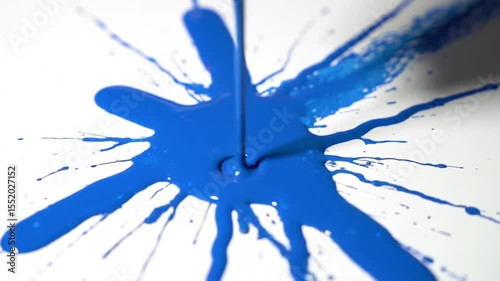 Minimalist Pour of Vibrant Blue Paint Spreading on White Canvas in Abstract Patterns