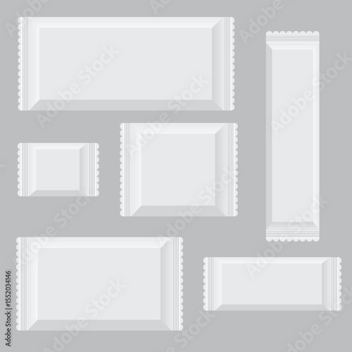 A collection of various sized sealed white packets are isolated against a gray background, creating a minimalist aesthetic suitable for product presentation.