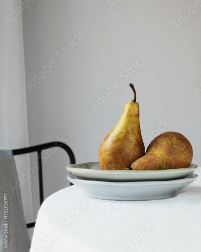 Fresh pear on ceramic plate with natural light
