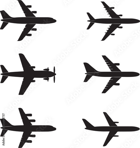 A vector illustration black airplane silhouettes viewed from a top down perspective, arranged on a clean white background