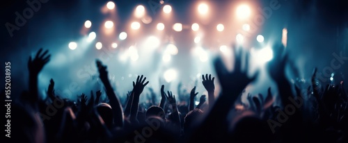 The vibrant crowd enjoying an electrifying concert with glowing lights.